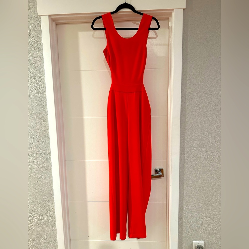 Bright orange jumpsuit with side cutouts